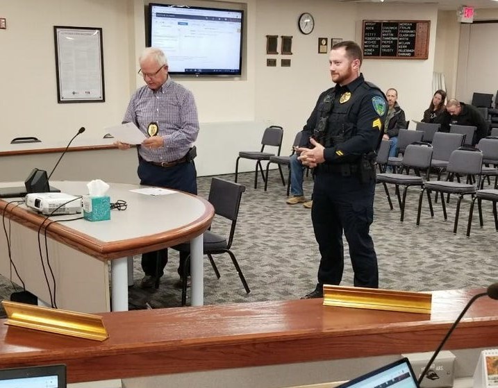Sergeant Derrick Hosick receiving an honor from Chief Bruce Lang.