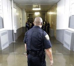 A Department of Corrections Officer walks to the Wasatch A-East block during a media tour Thursday, Feb. 26, 2015, at the Utah State Correctional Facility in Draper, Utah.