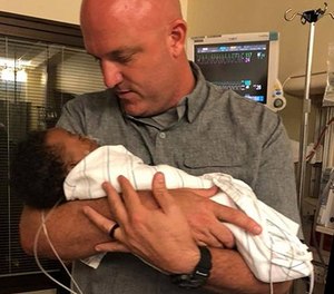 Deputy Jeremie Nix cradles Kingston, the baby he rushed to the hospital. “I was just in the right place at the right time,” Nix said.