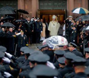 Pallbearers transport the casket of Jersey City Police Detective Joseph Seals in to St. Aeden's church for the funeral services in Jersey City, N.J.