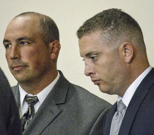 In this Aug. 18, 2015 file photo, former Albuquerque Police Detective Keith Sandy, left, and Officer Dominique Perez speak with attorneys during a preliminary hearing in Albuquerque, N.M.