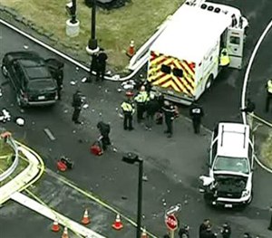 In this image made from video and released by WJLA-TV, authorities investigate the scene of a accident near a gate to Fort Meade, Md., on Monday, March 30, 2015.