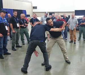 Jared Wihongi demonstrates how students must control the arm of their attacker to prevent their ability to strike again.