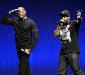 N.W.A. members Dr. Dre, left, and Ice Cube salute the crowd after speaking at a Universal Pictures presentation.