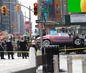A car rests on a security barrier in New York's Times Square after driving through a crowd of pedestrians. (AP Photo/Mary Altaffer)