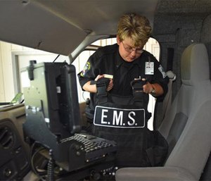 A paramedic shows a ballistic vest in one of the ambulances used by personnel.