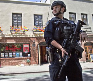 In this June 12, 2016 file photo, an armed police officer stands guard outside the Stonewall Inn, in New York after a Florida gunman's attack at a gay nightclub spread fear of more attacks. (AP Photo/Mary Altaffer, File)