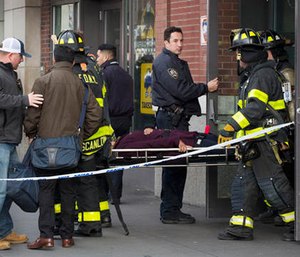 An injured passenger is taken on a gurney by firefighters from the Atlantic Terminal in the Brooklyn borough of New York after a Long Island Rail Road train hit a bumping block, Wednesday, Jan. 4, 2017.