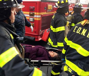 An injured passenger is taken on a gurney by firefighters from Atlantic Terminal in the Brooklyn borough of New York after a Long Island Rail Road train hit a bumping block, Wednesday, Jan. 4, 2017.