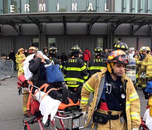 An injured passenger is taken from the Atlantic Terminal in the Brooklyn borough of New York after a Long Island Rail Road train hit a bumping block, Wednesday, Jan. 4, 2017.