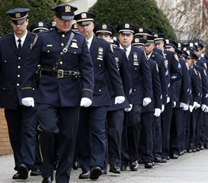 New York City police officers march before funeral services for police officer Wenjian Liu at Aievoli Funeral Home, Sunday, Jan. 4, 2015, in the Brooklyn borough of New York.