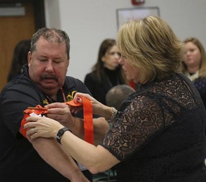 Two staffers from the Three Village Central School District in Stony Brook, N.Y., practice applying a tourniquet to one another during a first aid training session at Stony Brook University, Tuesday, Nov. 29, 2016, in New York.