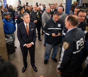 Patrolmen's Benevolent Association President Patrick J. Lynch, left, waits to go inside of courtroom to listen to the arraignment at the Bronx Criminal Court, Monday, Feb. 10, 2020, in New York. (AP Photo/Eduardo Munoz Alvarez)