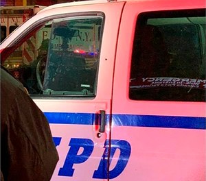 This photo provided by the New York Police Department shows a police van with a bullet hole above the door handle after a shooting in the Bronx borough of New York on Saturday, Feb. 8. (Photo/AP)