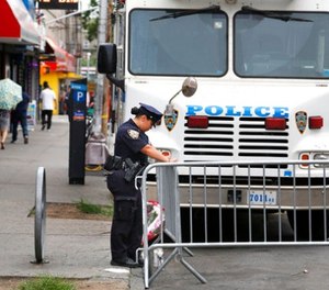 A police officer works near the site where an officer was killed in the Bronx section of New York, Thursday, July 6, 2017.