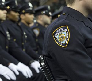 In this Dec. 29, 2014, file photo, new recruits attend their New York Police Academy graduation ceremony at Madison Square Garden in New York.