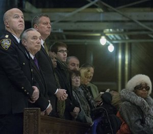 From left, NYPD's Chief of Department James O'Neill, NYPD Commissioner Bill Bratton, and New York City Mayor Bill de Blasio, attend mass at St. Patrick's Cathedral, Sunday, Dec. 21, 2014, in New York.