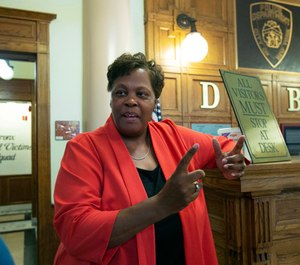 In this Friday, Aug. 23, 2019, photo, New York Police Department Deputy Chief Judith Harrison, in charge of the Special Victims Division, speaks at the front desk of the NYPD Detective Bureau in the Bronx borough of New York. (AP Photo/Richard Drew)