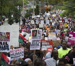 Demonstrators march to protest the death of Eric Garner, Saturday, Aug. 23, 2014, in the Staten Island borough of New York.