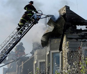 Firefighters battle an early morning apartment fire Monday in Oakland, Calif.
