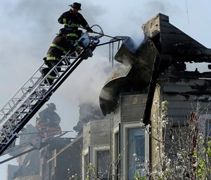Firefighters battle an early morning apartment fire Monday in Oakland, Calif.