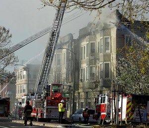 Firefighters battle the apartment fire in Oakland, Calif.