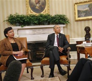 President Barack Obama, center, with Attorney General Loretta Lynch, left, sit during their meeting in the Oval Office of the White House in Washington, Tuesday, July 19, 2016.