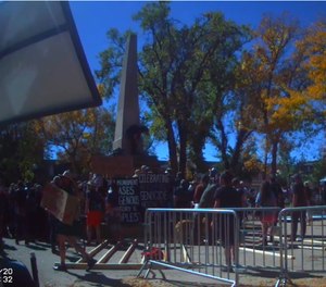 This still from bodycam video shows a crowd surrounding a war monument in Santa Fe during an Indigenous People's Day demonstration on October 12, 2020. (Photo/Santa Fe Police Department)