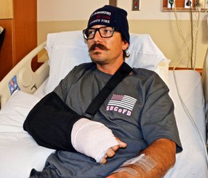 Mike Kordich, a firefighter from Rancho Cucamonga, Calif., answers questions from his hospital bed at Sunrise Hospital in Las Vegas.