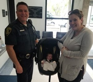Officer Brandon Kindle with Audra KcKinnon and baby Maeve