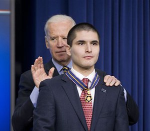 Vice President Joe Biden awards John Michael Capano, son of ATF special agent John Francis Capano, the Medal of Valor during a ceremony in the Old Executive Office Building on the White House Complex in Washington, Wednesday, Feb. 11, 2015.
