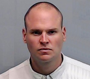 This photo provided July 21, 2016 by the Fulton County Sheriff's Office shows former Atlanta police officer James Burns at his booking at Fulton County Jail.