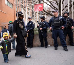 Men leave the Islamic Cultural Center of New York under increased police security following the shooting in New Zealand, Friday, March 15, 2019, in New York.