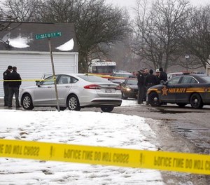 Police investigate the scene of a shooting in Westerville, Ohio, on Saturday, Feb. 10, 2018. Westerville police have confirmed that two officers have been fatally shot at a home in the Columbus suburb. A police statement says the officers responded to a 911 hang-up call around 11:30 a.m. and were shot after they arrived at a residence. A suspect is reportedly in custody.