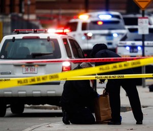 Crime scene investigators collect evidence from the pavement as police respond to an attack on campus at Ohio State University, Monday, Nov. 28, 2016, in Columbus, Ohio.