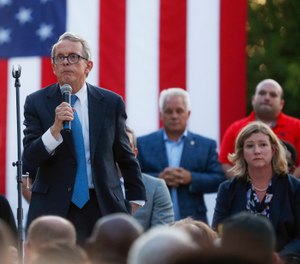 Ohio Gov. Mike DeWine, left, speaks alongside Dayton Mayor Nan Whaley, right, during a vigil at the scene of a mass shooting, Sunday, Aug. 4, 2019, in Dayton, Ohio. (AP Photo/John Minchillo)