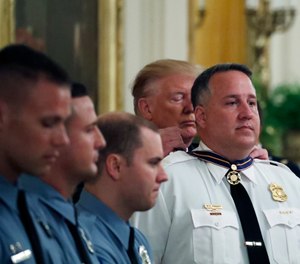 President Donald Trump presents the Medal of Valor to Dayton Police officer Sgt. William Knight, one of six Dayton police officers in the East Room of the White House in Washington, Monday, Sept. 9, 2019, for stopping a mass shooter in August in Dayton, Ohio. (AP Photo/Alex Brandon)