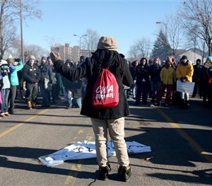 Alanna Galloway speaks to a crowd in front of a police precinct Saturday, Nov. 21, 2015, in Minneapolis.