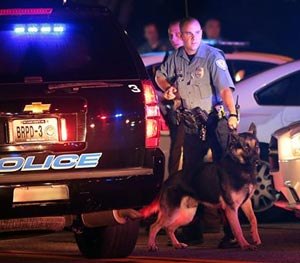 Police officers patrol the area Sunday, Aug. 10, 2014, in Ferguson, Mo.