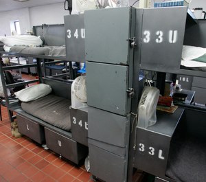 In this Monday, May 10, 2010, inmates in unit four of the John Lilley Correctional Center in Boley, Okla., are housed in a building originally built as a dining facility. Shown here are the bunk beds and limited storage space allocated to each inmate. Oklahoma has the nation's highest incarceration rate, overcrowded prisons and skyrocketing costs. (AP Photo/Sue Ogrocki, File)