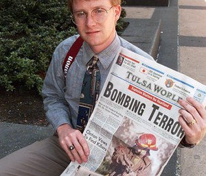 Freelance photograpaher and bank clerk Charles H. Porter IV shows off a copy of the Tulsa World Thursday, April 20, 1995, in Oklahoma City, that displays his photograph on the front page of a fireman with a baby victim from the Oklahoma City car bomb blast. (AP Photo/David Longstreath)