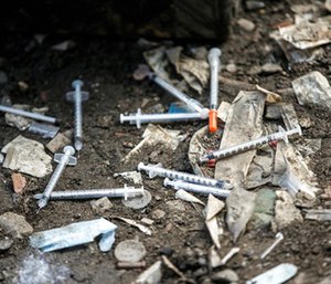 Used needles litter the ground at an open air drug market along Conrail train tracks in the Kensington section of Philadelphia. (Michael Bryant /The Philadelphia Inquirer via AP