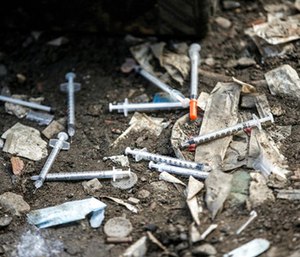 Used needles litter the ground at an open air drug market along Conrail train tracks in the Kensington section of Philadelphia. (Michael Bryant /The Philadelphia Inquirer via AP
