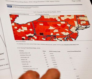 Assistant U.S. Attorney Robert Cessar shows a map illustrating the rates of opioids prescriptions by county during an interview in Pittsburgh.