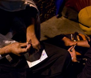 Two homeless drug addicts inject themselves with heroin in the Skid Row area of downtown Los Angeles.