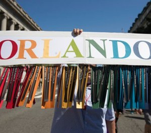 Gil Mendez, of San Francisco, holds a sign to honor the victims of the shooting at the Pulse Nightclub in Orlando, Fla., as he marches during the Equality March for Unity and Pride in Washington, Sunday, June 11, 2017. (AP Photo/Carolyn Kaster)