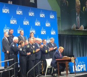 President Donald Trump signs an executive order establishing a new executive Commission on Law Enforcement and the Administration of Justice.