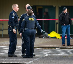 Eugene police secure the scene in front of Cascade Middle School in Eugene, Ore., Friday Jan. 11, 2019, after an officer involved shooting. (Chris Pietsch/The Register-Guard via AP)