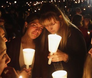 Kristen Sterner, left, and Carrissa Welding, both students of Umpqua Community College, embrace each other during a candle light vigil for those killed during a fatal shooting at the college, Thursday, Oct. 1, 2015, in Roseburg, Ore.