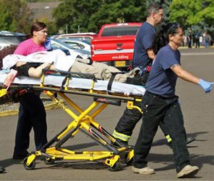 Authorities carry a shooting victim away from the scene.